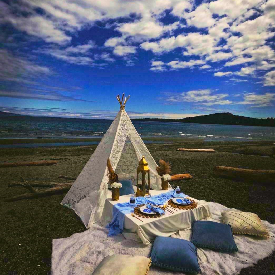 Lace teepee beach picnic under a dramatic sky