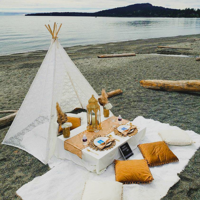 Beach teepee picnic with terracotta runner, pampas and gold lanterns