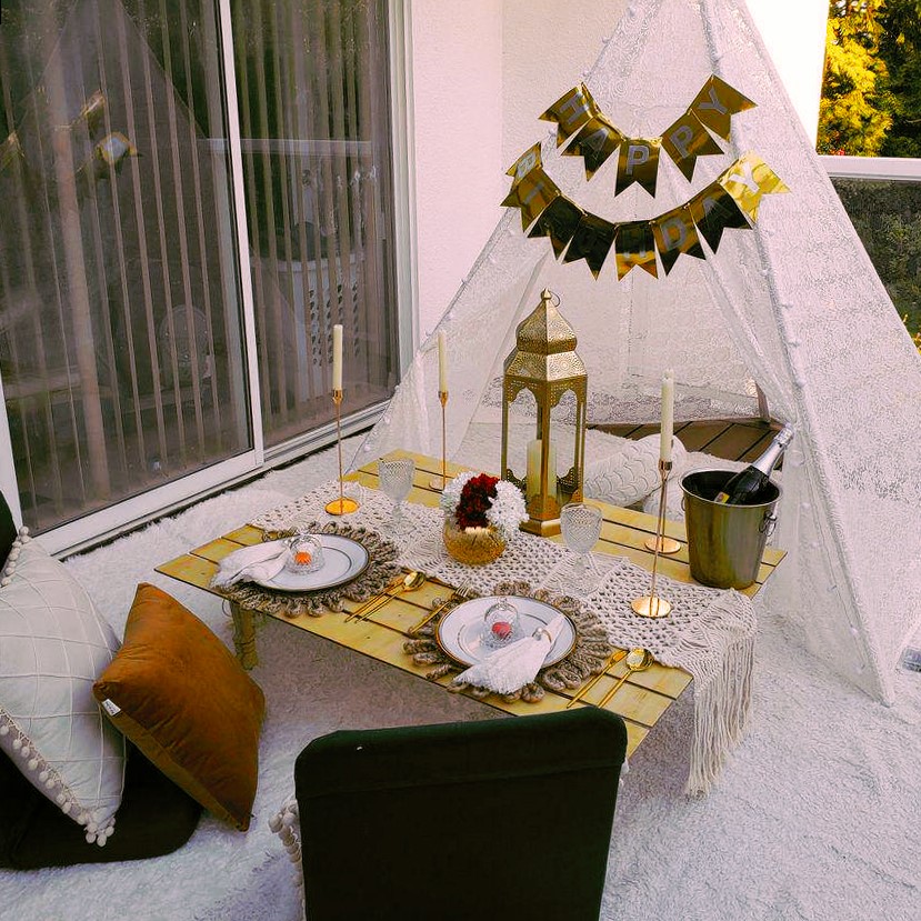 A milestone birthday celebration styled with a gold banner and champagne