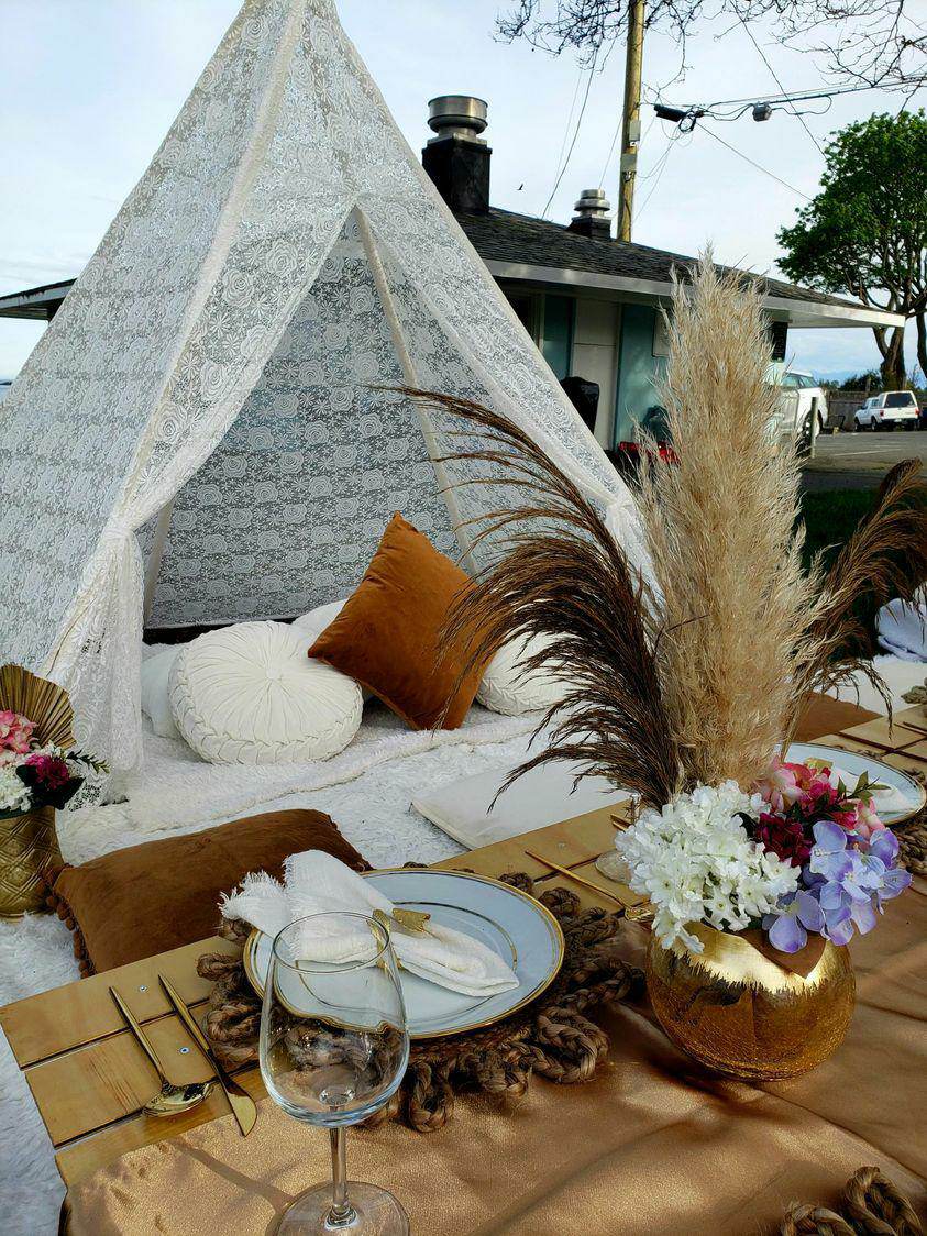 Lanterns, dried palm and rattan chargers styled on a table