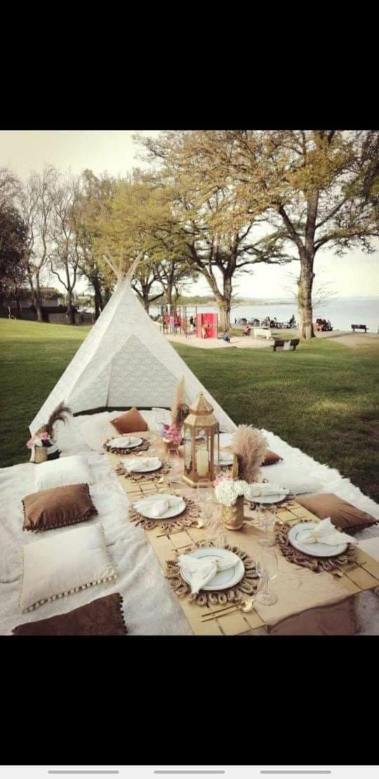 Lace teepee picnic in a waterfront park
